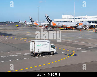 Gate Gourmet Catering Truck auf dem Rollfeld in der Nähe von Jetstar Flugzeuge am Flughafen Sydney, Domestic Terminal, Australien Stockfoto