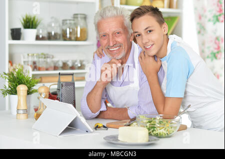 Älterer Mann mit Enkel Vorbereitung Abendessen in der Küche Stockfoto