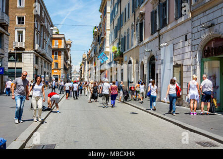 Rom, Italien, Juni 2015: Römer und Touristen entlang der berühmten Via del Corso Einkaufsstraße in Rom an einem sonnigen Tag im Frühsommer bummeln Stockfoto