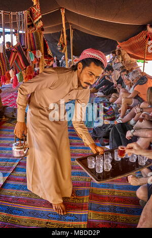 Junge beduinischen Tee zu den Touristen dienen, Wadi Rum Wüste, Jordanien Stockfoto