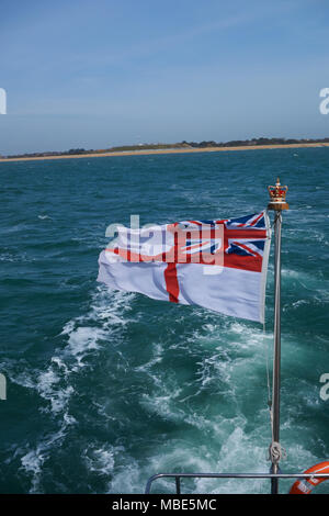 Eine britische White Ensign fliegen von der Rückseite der Royal Navy HMS Dasher P 2000 P280 im Sonnenlicht. Stockfoto