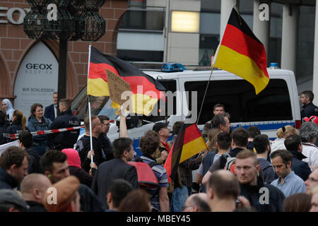 Mainz, Deutschland. 09 Apr, 2018. Rechtsextreme Demonstranten Welle deutsche Fahnen an der Rallye. Rund 50 Rechtsextreme Demonstranten sammelten sich in der Innenstadt von Mainz, gegen die deutsche Regierung zu protestieren, für die Schließung der Grenzen und gegen Flüchtlinge unter dem Motto 'MErkel hat zu gehen'. Sie wurden von rund 400 Zähler Gehechelt-Demonstranten. Quelle: Michael Debets/Pacific Press/Alamy leben Nachrichten Stockfoto