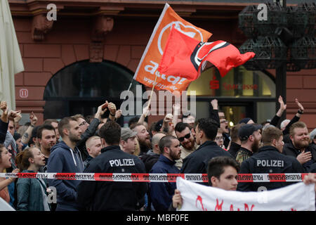 Mainz, Deutschland. 09 Apr, 2018. Der Zähler Demonstranten wave Fahnen und Banner führen. Rund 50 Rechtsextreme Demonstranten sammelten sich in der Innenstadt von Mainz, gegen die deutsche Regierung zu protestieren, für die Schließung der Grenzen und gegen Flüchtlinge unter dem Motto 'MErkel hat zu gehen'. Sie wurden von rund 400 Zähler Gehechelt-Demonstranten. Quelle: Michael Debets/Pacific Press/Alamy leben Nachrichten Stockfoto