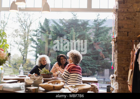 Frauen Freunde mit Smart Phone im Cafe Shop Fenster Stockfoto