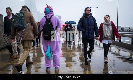 London, Großbritannien. 11. April 2018. UK Wetter: eine Spendenkampagne für die Meningitis Research Foundation steht auf der London Bridge die Pendler ihre Weise auf einen verregneten Tag in der Hauptstadt zu arbeiten (c) Paul Swinney/Alamy Leben Nachrichten machen Stockfoto