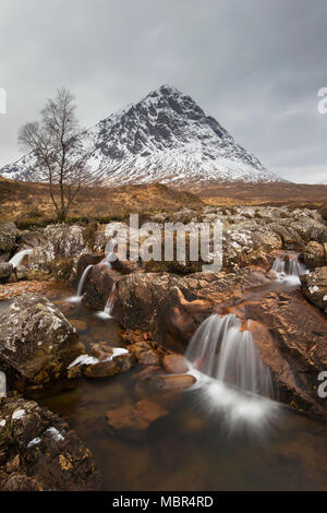 Schottische Berg Buachaille Etive Mòr und Wasserfall auf dem Fluss Coupall im Winter im Glen Etive in der Nähe von Glencoe in den Highlands von Schottland, Großbritannien Stockfoto