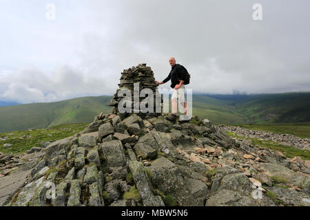 Wanderer auf dem Gipfel Cairn der Carrock fiel, Nationalpark Lake District, Cumbria, England, Großbritannien Stockfoto