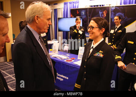 CRYSTAL CITY, Virginia (Jan. 11, 2018) der Sekretär der Marine Richard V. Spencer, Links, spricht mit Leutnant Rachel Messina, ein Kampf Taktik Kursleiter (WTI) zugewiesen, um die integrierte Luft- und Raketenabwehr Aufteilung der Naval Oberfläche und Mine Warfighting Development Center (SMWDC), an der 30. jährlichen Oberfläche Marine Association (SNA) Nationales Symposium. SMWDC ist einer von fünf der Marine Warfighting Entwicklungszentren und seine Mission ist die Letalität und taktischen Kenntnisse der Oberfläche tritt in allen Bereichen zu erhöhen. (U.S. Marine Foto von Leutnant Matthew A. Stroup/Freigegeben) Stockfoto