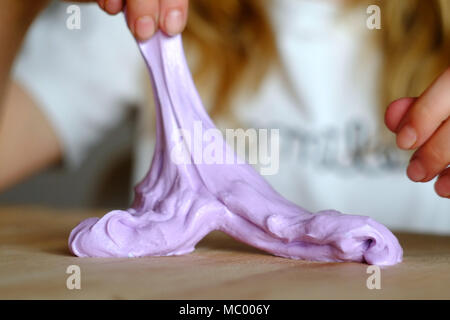 Kind mit hausgemachten Schleim. Die neuen Verrücktheit verwendet Borax und PVA Leim und Farbe bunte Mischungen zu machen. Stockfoto