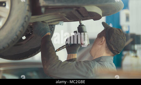 Mechaniker schraubt Detail des Autos in der Motorhaube - KFZ-Service Reparatur, Nahaufnahme Stockfoto