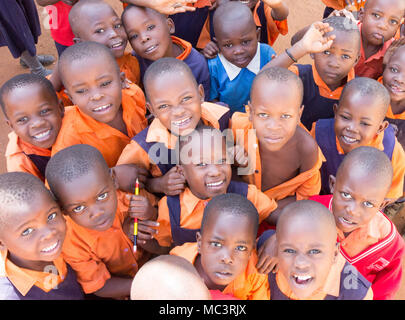 Uganda. 13. Juni 2017. Eine Gruppe von Happy Grundschulkinder lächeln, lachen und winken an einer Grundschule. Stockfoto