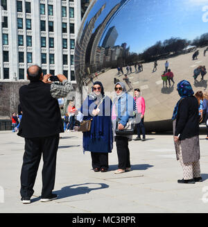 Eine Familie posieren für selfies mit Chicago's 'Bean' im Millennium Park an einem warmen Frühlingstag. Stockfoto