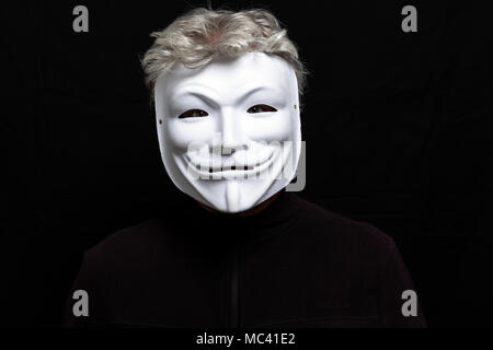 Grauhaariger Mann in anonymen Maske Stockfoto
