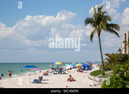 Urlauber in Naples, Florida genießen Aktivitäten am Strand. Sonnenbaden und Spaß am Strand. Stockfoto