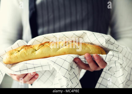 Frau Hände halten frisch gebackenes Brot. Französisches Baguette, Bäckerei Konzept, hausgemachte Speisen, gesunde Ernährung. Platz kopieren Stockfoto