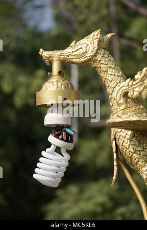 Dekorative Lampe mit Golden Swan Kamm aus der thailändischen Mythologie, wissen wie Hong Tong oder Hongkong. Die beschädigten Energiesparlampe hängt an eine öffentliche Beleuchtung Lampe. Stockfoto