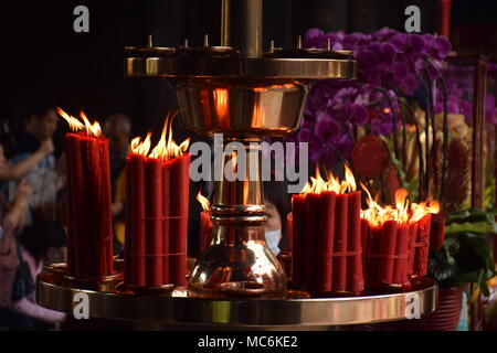 Rote Kerzen mit unscharfen Leute im Hintergrund innen Longhsan buddhistischen Tempel beten in Taipei, Taiwan Stockfoto