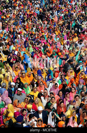 Mitglieder der Sikh Gemeinschaft folgen dem Guru Granth Sahib, dem heiligen Buch der Sikhs, während der nagar Kirtan Prozession durch Gravesend, Kent, die Teil der Sikh Vaisakhi Festival im Frühjahr Ernte für die Bauern und Gemeinschaften im Punjab in Nordindien Kennzeichnung. Stockfoto