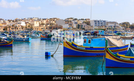 Marsaxlokk, Malta Insel. Traditionelle Fischerboote luzzus mit hellen Farben verankert im Hafen von Marsaxlokk Stockfoto