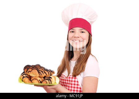 Kleines Mädchen kochen und Croissant mit Schokolade Stockfoto