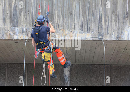 Die Hayward Gallery, Southbank, London, 14. April 2018. Zwei Ingenieure arbeiten an der Außenwand der Hayward Gallery, im Hinblick auf die Zuschauer auf der Waterloo Bridge, spannte in, Abseilen in der Höhe ein Teil der Struktur zu prüfen, und führen Sie einige Reparatur- und Wartungsarbeiten. Credit: Imageplotter Nachrichten und Sport/Alamy leben Nachrichten Stockfoto