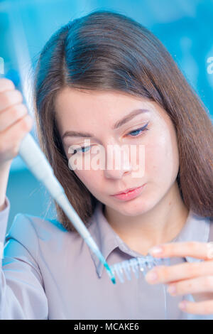 Technikerin mit Pipette in Kop für DNA die gerichtliche Prüfung Stockfoto