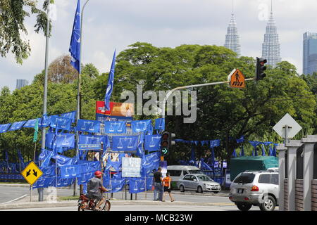 Kuala Lumpur, Malaysia. 15. April 2018. Die kommenden Mai 2018 allgemeine Wahlen wird erwartet, einen scharf angegriffenen Kampf zwischen der Regierungskoalition und der Opposition Alliance zu sein. In welche Richtung wird es gehen? Blaue Fahnen hier gesehen gehören zu den regierenden Barisan Nasional. Die berühmten Petronas Twin Towers ist im Hintergrund fotografiert. Credit: Beaconstox/Alamy Leben Nachrichten. Stockfoto