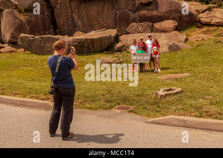 Gettysburg, PA, USA - 8. Juli 2013: Besucher posieren für ein Foto bei Devil's Den auf dem Schlachtfeld von Gettysburg. Stockfoto