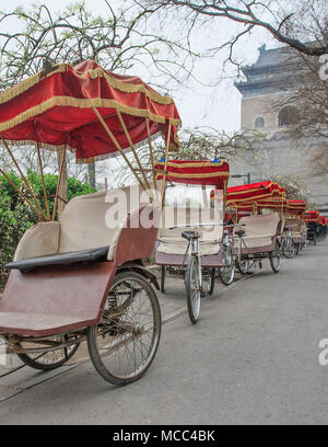 Rikscha's Park in den frühen Morgen um den berühmten Glockenturm in Peking, China Stockfoto