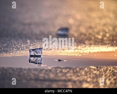 Shining Eisberge und Eisschollen, Eis Schlupfwinkeln reflektierten Strahlen in die glatte Wasseroberfläche. Treibeis in der Lagune. Stockfoto