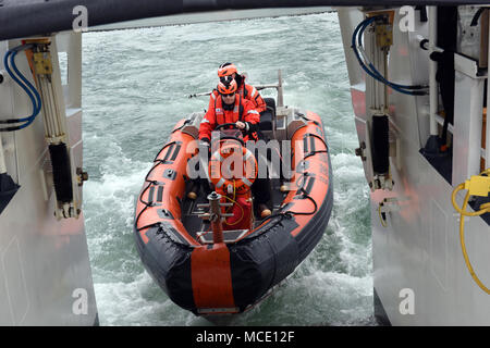 Coast Guard Unteroffiziere 1. Klasse Zachary Burgess und Jamie Martin, der bootsmann Gehilfen an Bord Cutter fliegende Fische, das Boot des Cutter während einer Übung aus Virginia Beach, Virginia, Feb 15, 2018 starten. Die 87-Fuß-patrouillenboot Crew das kleine Boot während der Suche und Rettung und Polizei Missionen nutzen, auch wenn die Yacht im Wesentlichen auch als Rettungsboot dient. (U.S. Coast Guard Fotos von Petty Officer Corinne Zilnicki/Freigegeben) Stockfoto