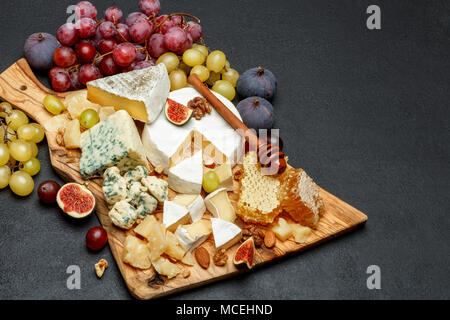 Camembert Käse mit Honig, Feigen, Walnüsse auf Holzbrett Stockfoto