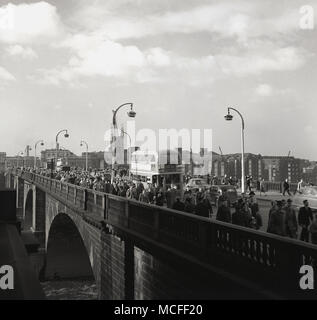 London, 1948, Überqueren von 'neuen' London Bridge von Southwark, die auf dem Weg zur Arbeit in London, England. Von John Rennie konzipiert, es öffnete sich 1831 und bestand aus 5 steinernen Bögen und ersetzt die früheren mittelalterlichen Brücke. Die Brücke wurde den verkehrsreichsten Punkt in London und einer der verkehrsreichsten, mit Tausenden von Fußgängern und Fahrzeugen es jede Stunde Überfahrt. Stockfoto