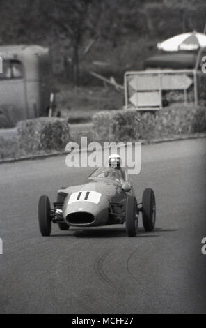 1960, historische, ein Einsitzer, geöffnet - fahrbare Rennwagen um eine Rennstrecke gefahren wird. Stockfoto