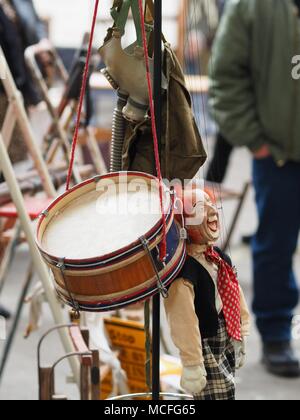 Drum clown Puppe und Gasmaske hängend an einem kleiderständer zu einem Antiquitäten Messe Stockfoto