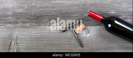 Unopen Flasche Rotwein mit Vintage Korkenzieher auf rustikalen Planken Stockfoto