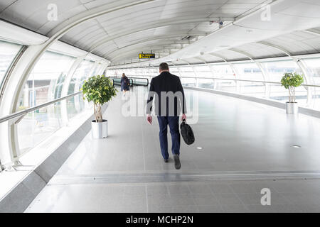 Männliche, Traveller, Passagier, Wandern, aus, Manchester, Flughafen, Terminal, Gebäude, zu, den, Bahnhof, Bus und Bahn, Bahnhöfe, Transport, Hub, England, Vereinigtes Königreich, Stockfoto