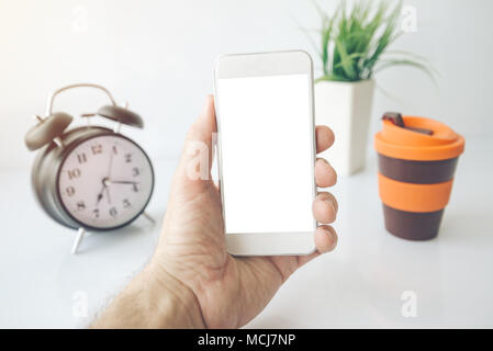 Handy morgendliche Routine wie E-Mails, Nachrichten oder Social Media, in der Nähe der männlichen Hand Smartphone mit leeren Bildschirm als Kopie Raum Stockfoto