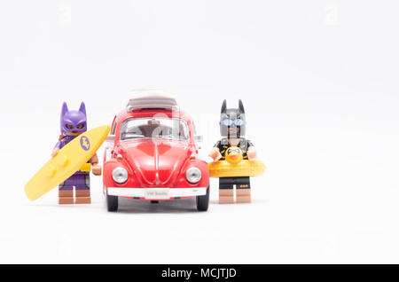 Mini Abbildung von bat Girl und Batman auf Urlaub mit Volkswagen Käfer. Lego Minifiguren sind von der Lego Gruppe hergestellt. Stockfoto