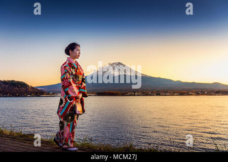 Asiatische Frau mit traditionellen japanischen Kimono auf dem Fuji Berg. Sonnenuntergang am Kawaguchiko See in Japan. Stockfoto