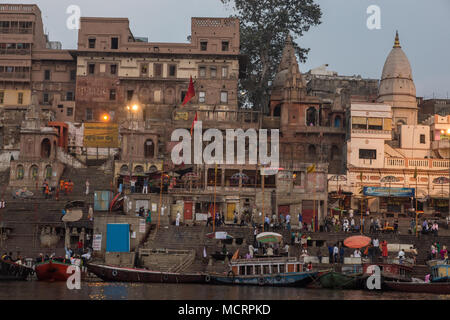 Pilger besuchen die Heilige Stadt und bunten Ruderboote auf den Ganges in Varanasi, Uttar Pradesh, Indien Stockfoto