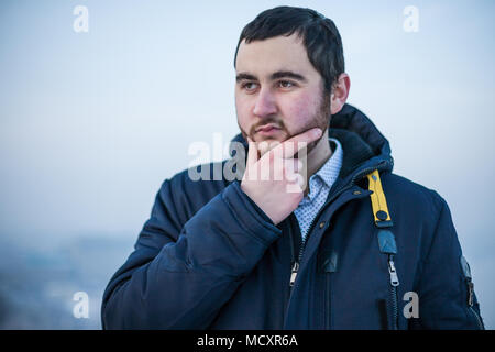 Portrait einer jungen konzentriert man Hand an das Kinn der Entscheidung Stockfoto