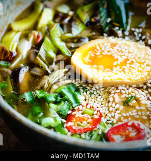 Ramen Suppe in der Schüssel. Reichen geschmack Hühnerbrühe mit Miso einfügen, gegrilltes Teriyaki Huhn, Lauch, Pilze, eingelegte Eier, Eiernudeln, Zwiebel, Chilli pe Stockfoto