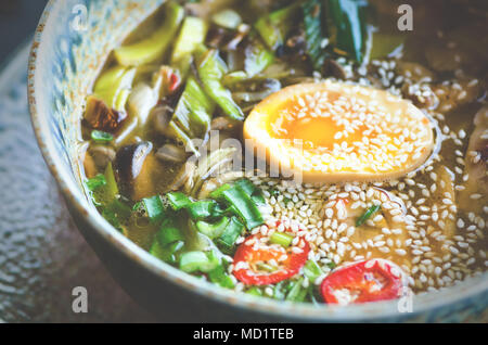 Ramen Suppe in der Schüssel. Reichen geschmack Hühnerbrühe mit Miso einfügen, gegrilltes Teriyaki Huhn, Lauch, Pilze, eingelegte Eier, Eiernudeln, Zwiebel, Chilli pe Stockfoto