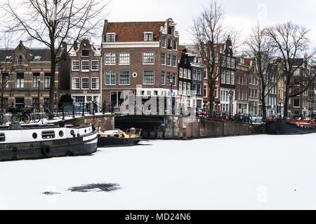 Herrlichen Blick auf die Grachten und Haus Boot mit Schnee während der Kaeltewelle in Februar 2018 auf einen sehr kalten Winter Tag eingefroren. Stockfoto