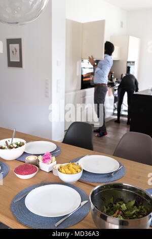 Den Tisch für vegetarische Gerichte einrichten - griechischer Salat, grün und schwarz Oliven und Rote Beete Hummus Stockfoto