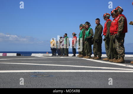 Us-Marines und Matrosen Verhalten ein Fremdkörper und Schmutz Spaziergang vor dem Flight Deck Operationen an Bord der San Antonio-Klasse amphibious Transport dock Schiff USS Anchorage LPD (23), 24. März 2018. Das Essex Amphibious Ready Gruppe und 13 Marine Expeditionary Unit sind vollständig integrieren zum ersten Mal vor dem Sommer Bereitstellung. Amphibische Squadron, MEU integration Training eine entscheidende Einsatz übung, die Navy-Marine Corps Team schnell zu planen und komplexe Operationen von Naval Versand ausführen. (US Marine Corps Foto von Cpl. Austin Mehlig) Stockfoto