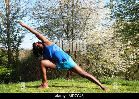 Ein Mann das Tun einer Yoga Übung im Freien Stockfoto