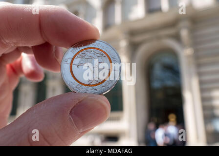 Abbildung - 19 April 2018, Deutschland, Hannover: Die neue 5-Euro Münze Sammler gehalten, eine Filiale der Deutschen Bundesbank zurück. Foto: Peter Steffen/dpa Stockfoto