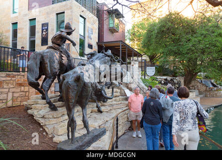 Touristen und T.D. Kelsey "nach Hause zu kommen um die briscoe "Skulptur außerhalb der Briscoe Western Art Museum, der River Walk, San Antonio, Texas, USA Stockfoto